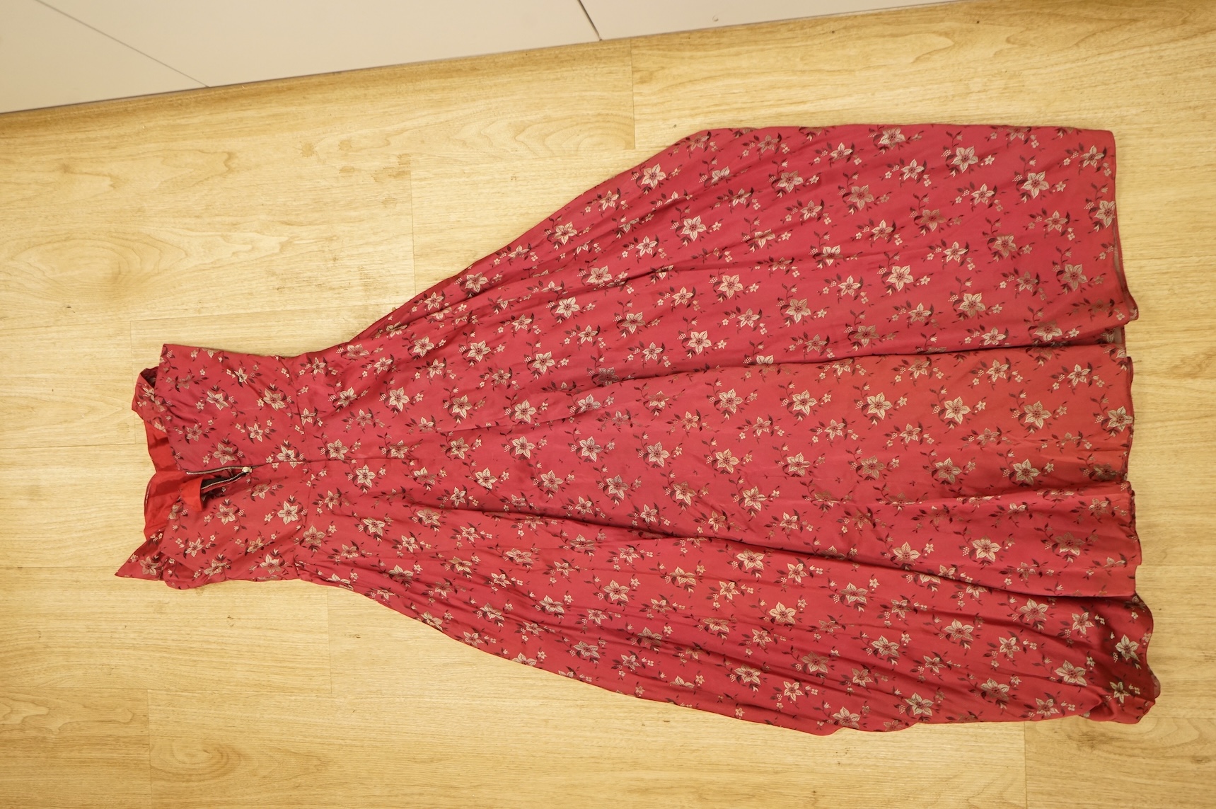 A late 1940’s black lace evening dress, a similar evening dress with black velvet ribbon detail, a maroon brocade halter neck evening dress and a dark mustard early 1950’s evening silk duster coat.